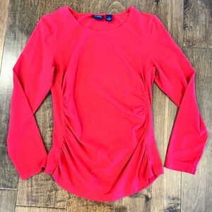 Pink long sleeved maternity shirt.